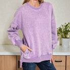 Model wearing SOFT HORIZONS CREWNECK in lavender, showcasing the fleece lined, hi-low hem design and front pockets.