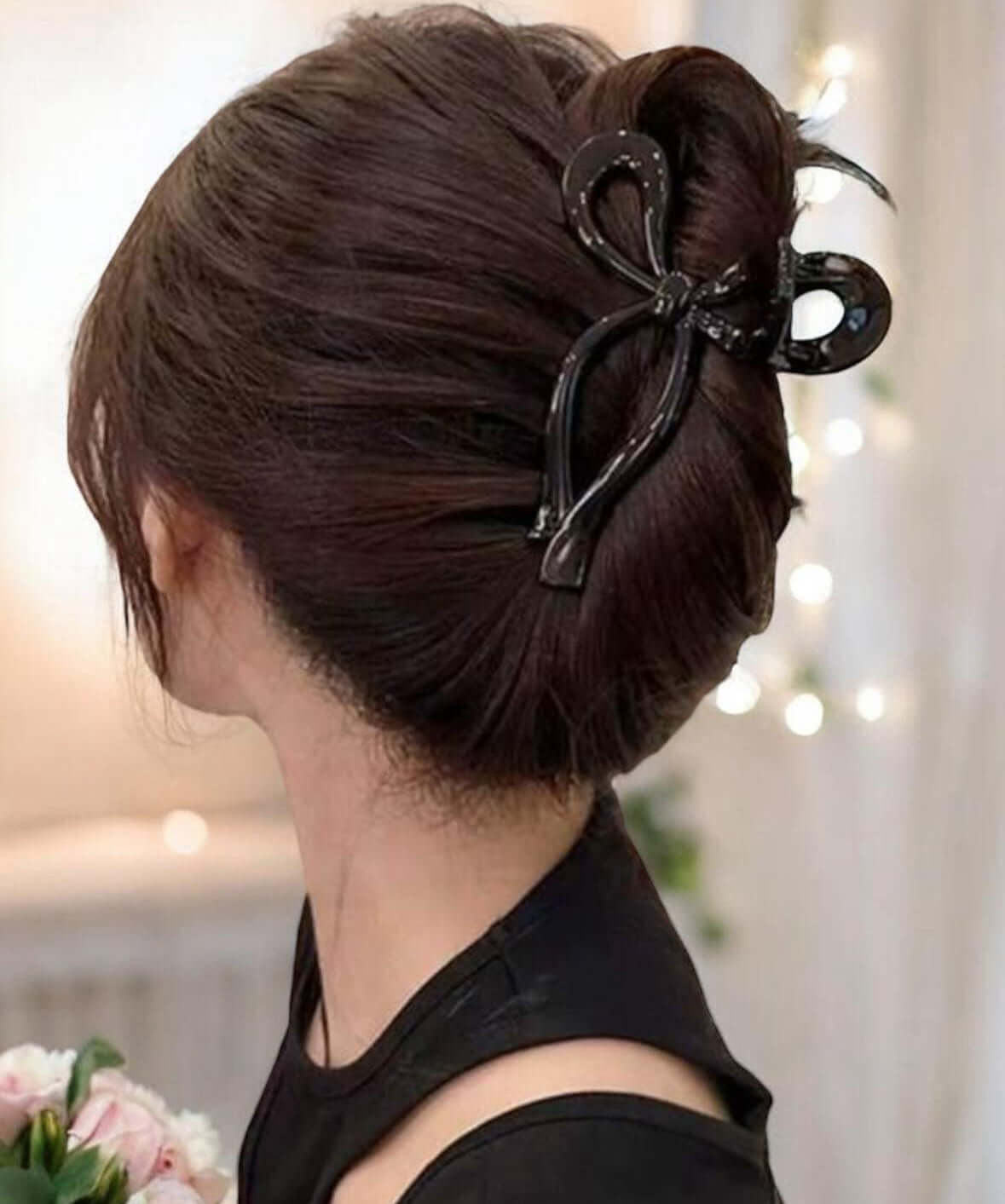 Elegant Tied and True hair clip holding a stylish bun, showcasing a chic bow design for versatile hairstyles.