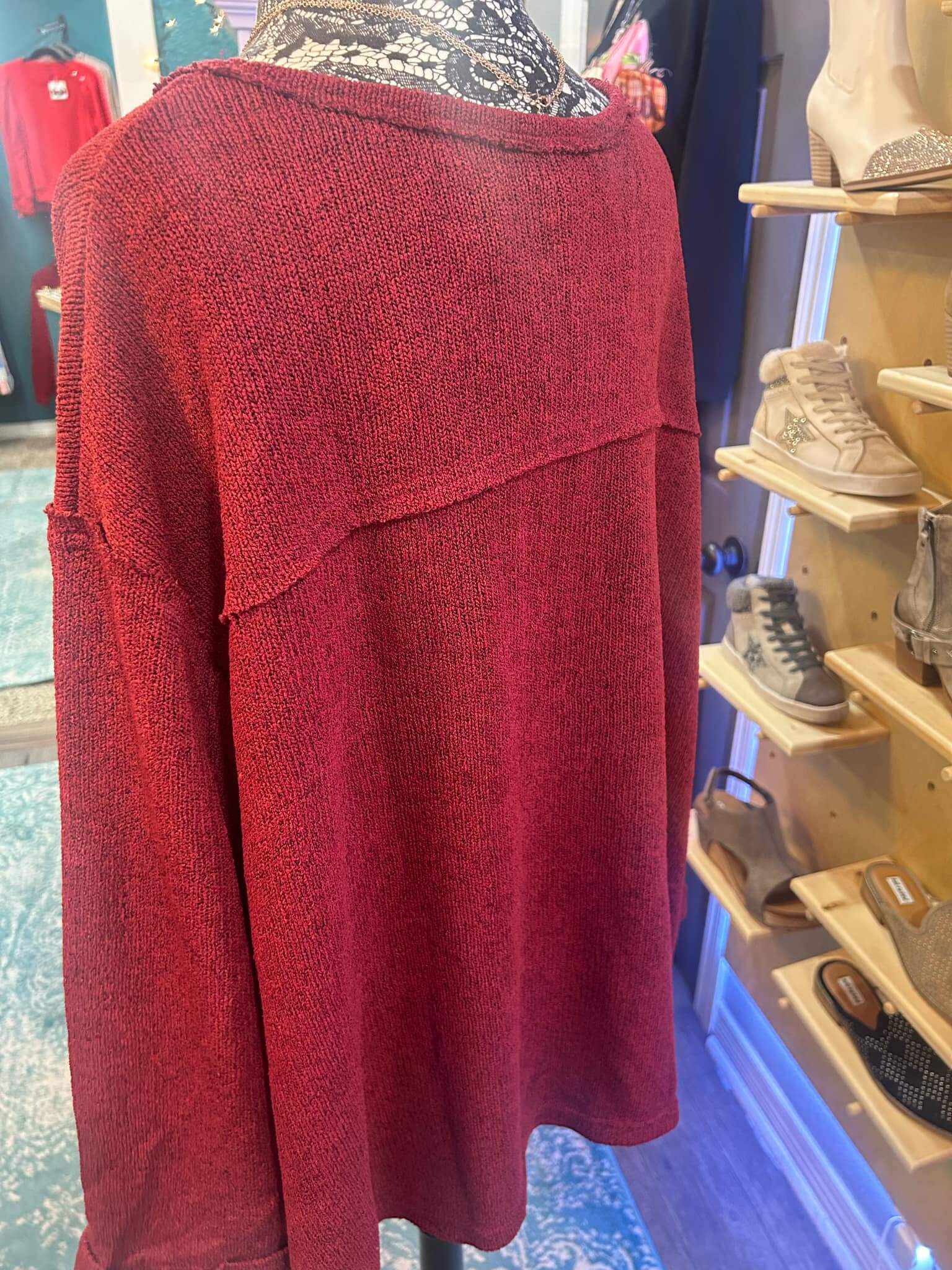 Dark red GIGIO PLUS GOING FORWARD top featuring long sleeves, round neck, and exposed seams, showcased on a mannequin.