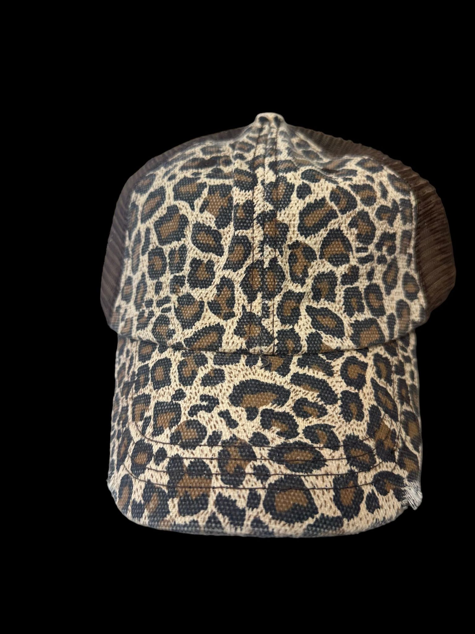 Stylish leopard print trucker hat with distressed twill design and mesh back, perfect for a chic look.