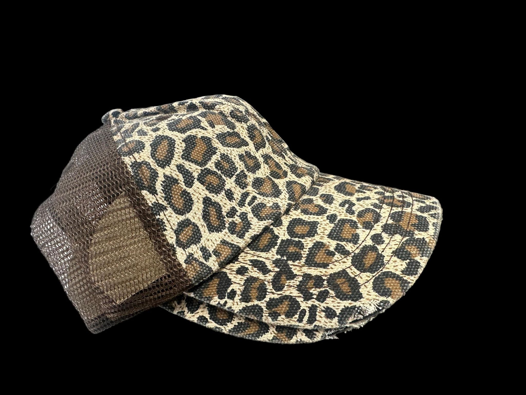 Leopard print trucker hat with mesh back and distressed design, perfect for a stylish comfy look.