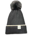 Black beanie with faux fur pom pom and smiley design, lined with Sherpa for comfort and style. One-size-fits-most winter accessory.