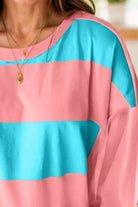 Vibrant blue and pink color block crew neck top with drop shoulder and striped pattern, perfect for layering and a playful style.