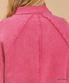 Back view of the hot pink 'That Pretty Feeling Top' showcasing its textured fabric and stylish design.