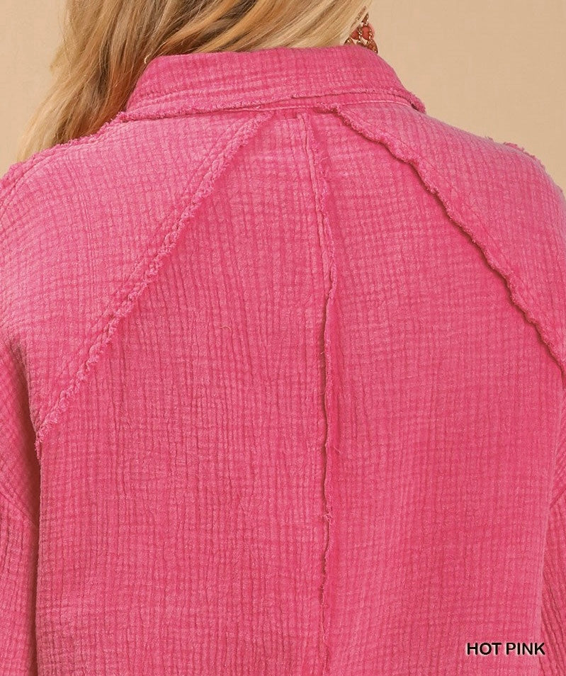 Back view of the hot pink 'That Pretty Feeling Top' showcasing its textured fabric and stylish design.