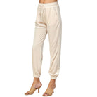 Beige velvet joggers by See & Be Seen, offering a soft and stretchy fit, perfect for any outfit. Model wearing XSmall size.