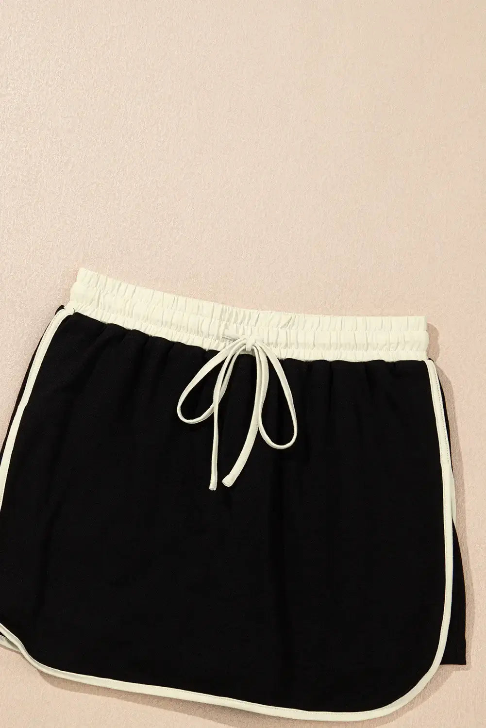 Black drawstring skort with white trim, part of the Boardwalk Breeze Skort Set, ideal for sporty and casual outfits.