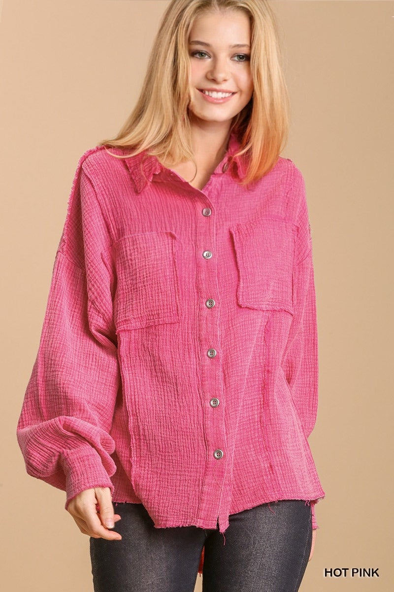 Woman wearing hot pink That Pretty Feeling Top with button-down design and high-low hem.