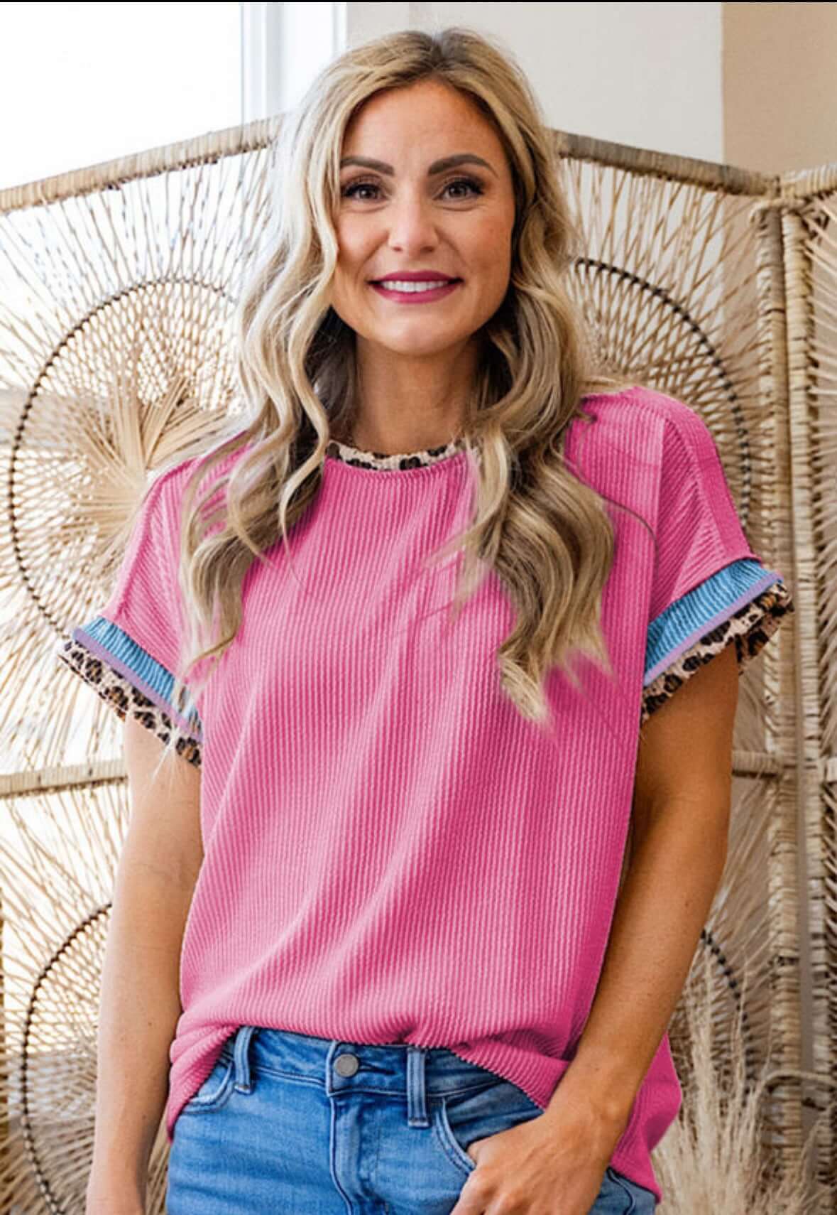 Model wearing Pure Instincts Top in taffy pink with leopard patchwork details and crew neck.