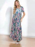 Model wearing the Watercolor Wonder maxi dress, featuring vibrant abstract floral design and relaxed fit.