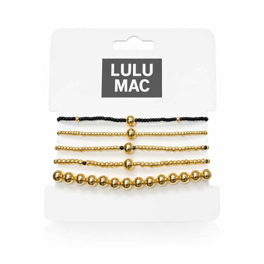 LULU MAC STACKED SERENITY 5 BRACELET SET featuring black and gold bracelets on a display card.