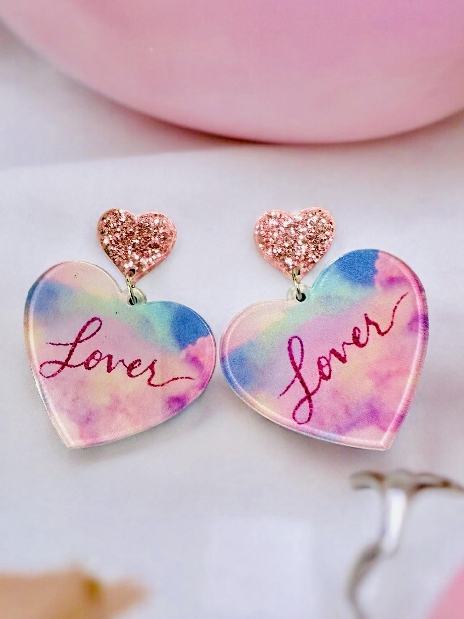 Colorful Lover Era Earrings, 2" long, 1.5" diameter, heart shape with pink sparkle accents, perfect for a statement look.