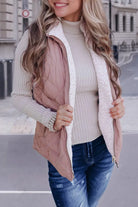 Woman wearing REVERSIBLE RETREAT VEST! in pink sherpa-lined quilted style, showcasing cozy fashion.