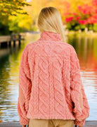 Woman wearing blush TEDDY BEAR SHERPA by Very J, showcasing cable pattern and mock neck, standing by a scenic lakeside in fall.