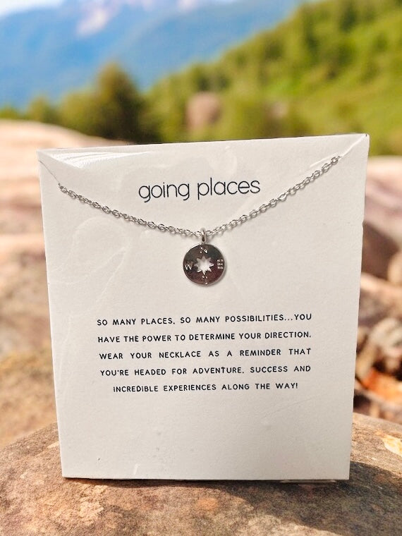 Silver-toned necklace with a charm and uplifting quote, perfect for adventure seekers and dreamers.