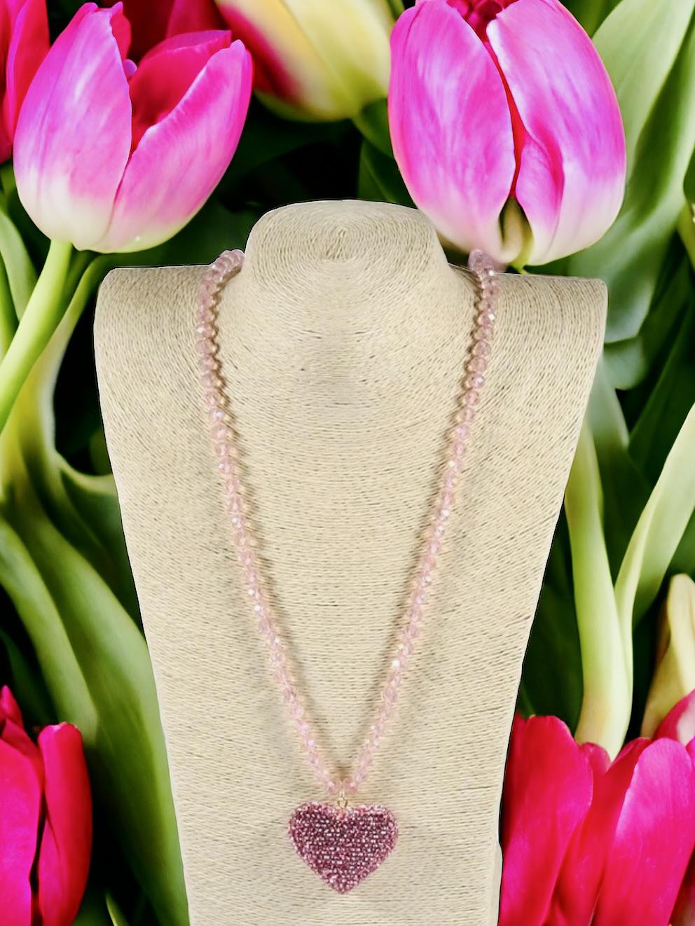 HEART STRINGS Necklace by Teal Tiger Boutique $8.00 Add some sparkle to your outfit with the HEART STRINGS Necklace! Featuring vibrant rhinestone hearts in pastel pink and rose red, this necklace adds a touch of romance to any look. The long strand of bea