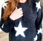 RISING STAR Sweater by Teal Tiger Boutique $20.00 Indulge in luxurious comfort with our ultra soft teddy bear sweater adorned with delicate stars. This premium piece offers a true to size fit and unparalleled softness. Choose from our classic black or ele