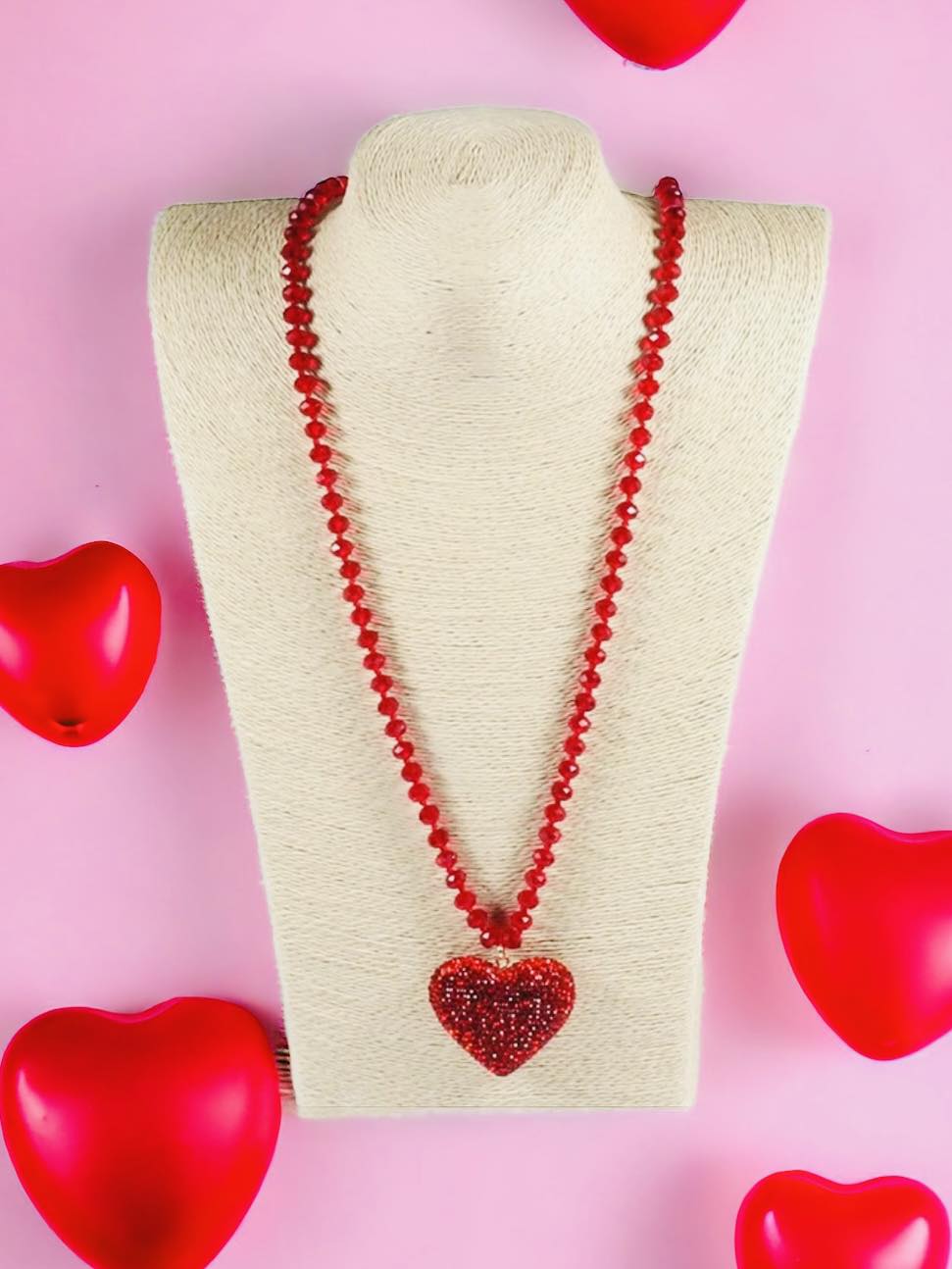 HEART STRINGS Necklace by Teal Tiger Boutique $8.00 Add some sparkle to your outfit with the HEART STRINGS Necklace! Featuring vibrant rhinestone hearts in pastel pink and rose red, this necklace adds a touch of romance to any look. The long strand of bea