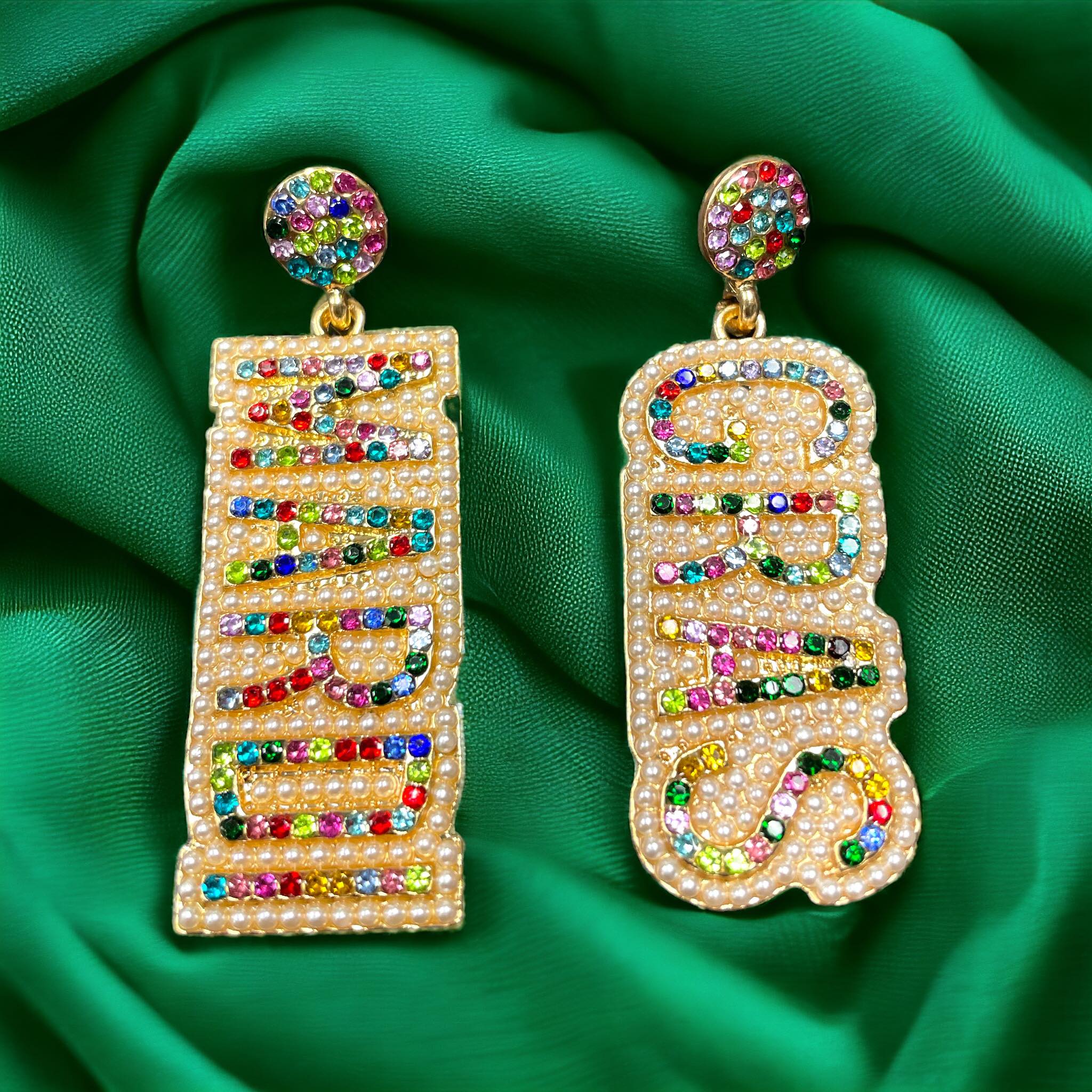 MARDI GRAS earrings with colorful rhinestones on a vibrant green background, celebrating New Orleans culture.