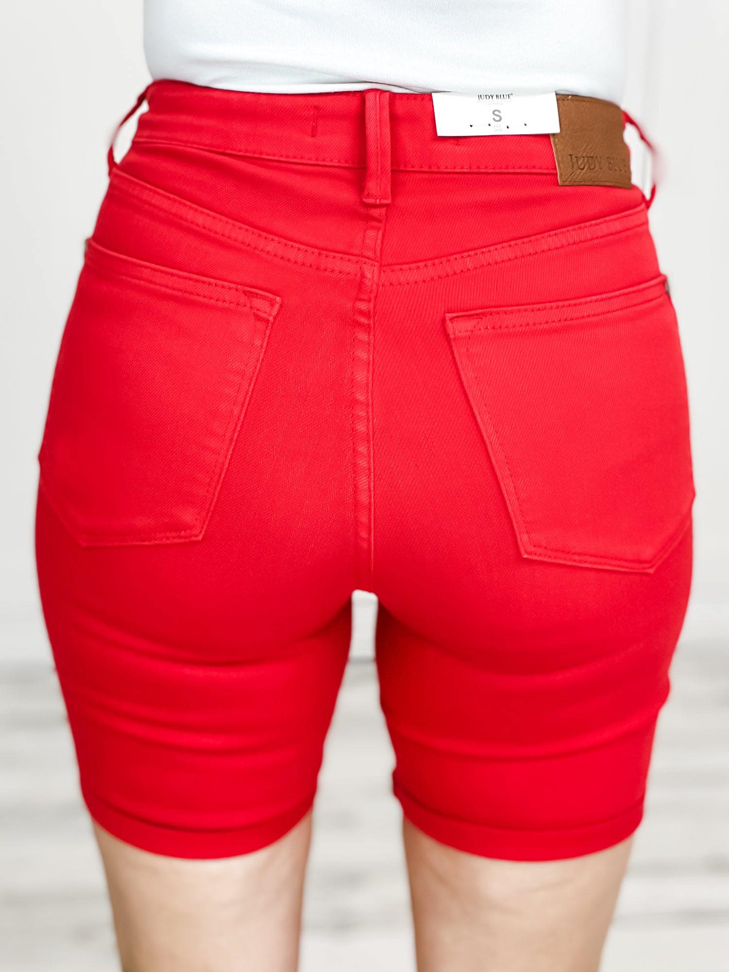 Back view of JUDY BLUE LOVE tummy control shorts in vibrant red, showcasing pockets and fitted design.