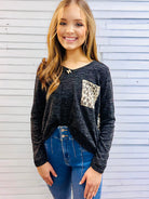 UNTAMED STYLE Top by Hemish in Charcoal by HEMISH $20.00 Embrace a daring style with this bold top featuring a luxe, long-sleeved design. Crafted with expertise, it showcases dynamic color-block elements and a wild animal print on the pocket and back pane