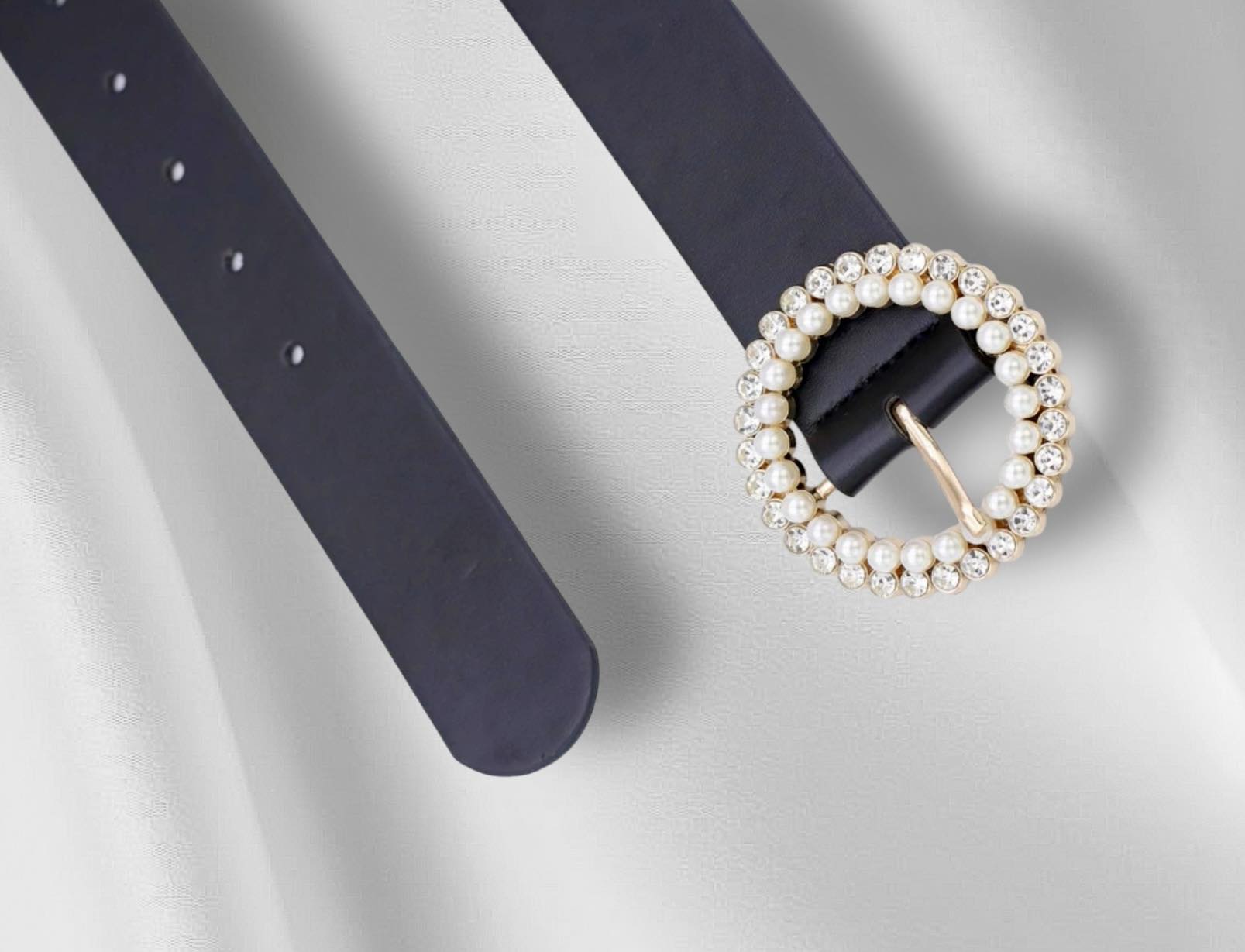Elegant black belt with pearl and rhinestone buckle, perfect for adding sophistication to any outfit.