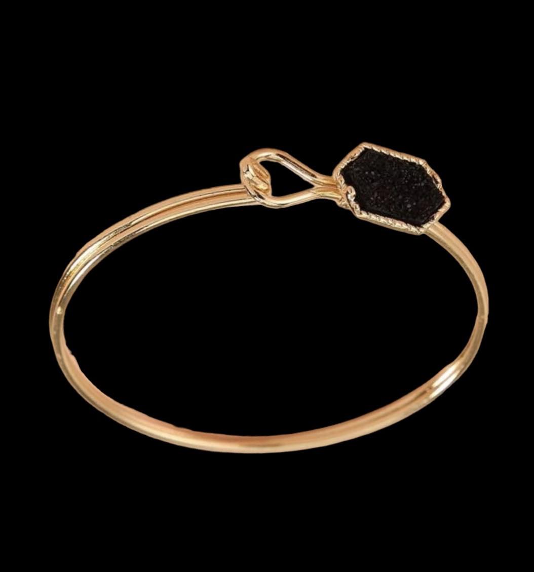 SPARKLING SABLE Bracelet featuring a sable geometric stone and gold-tone bangle with hook closure.