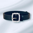 Pearl Accent Belt (black) by Teal Tiger Boutique $15.00 Indulge in the luxurious elegance of our black belt, adorned with a square faux pearl buckle and highlighted by a stunning gold tone underlay. 1.2 inches wide and 40 inches long Teal Tiger Boutique