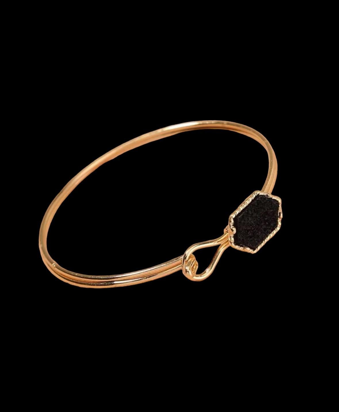 SABLE bracelet with a sable-colored geometric stone and gold-tone bangle, featuring a hook closure.