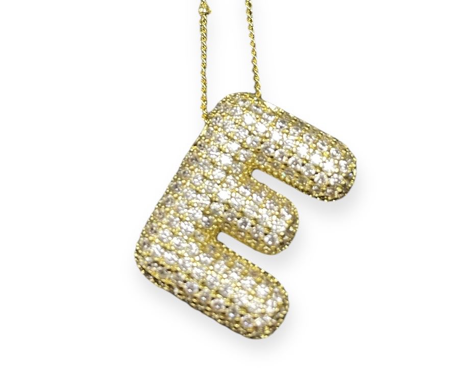 Gold tone bubble pendant necklace with rhinestone embellishments in a playful letter 'E' design.