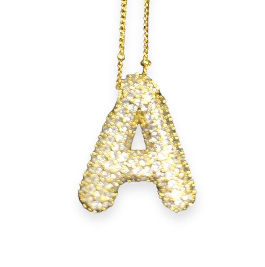 Gold tone rhinestone-encrusted letter 'A' necklace with a delicate chain.