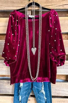 Scarlet Precious Pearls Velvet Top by Umgee with pearl-accented sleeves and necklace, paired with distressed jeans.