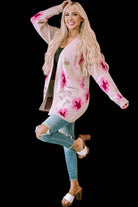 Woman wearing a CARDI GIRL floral open-front cardigan with jeans and sandals, showcasing its elegant and fashionable design.