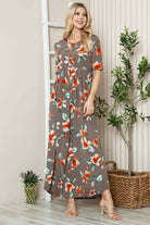 Women's floral shirred maxi dress with short sleeves in olive, featuring a flowy silhouette, model at 5'10".