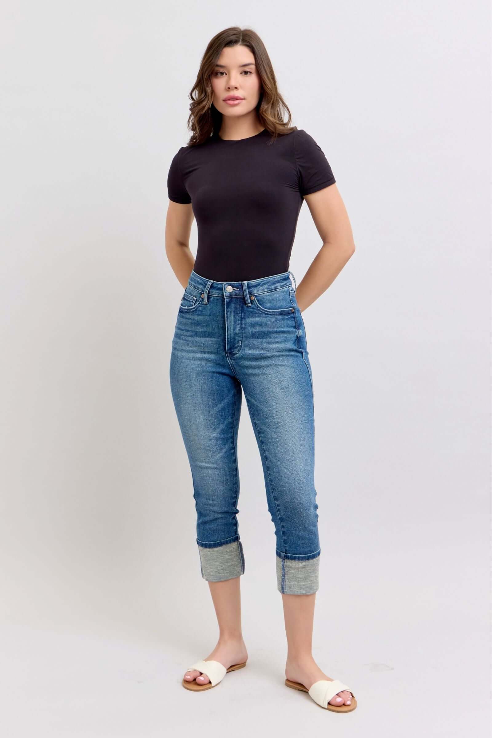 Model wearing JUDY BLUE Charli Capris, high waist medium wash cuffed jeans, showcasing tummy control and no distressing.