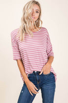 Woman in soft mauve striped tee top, relaxed fit, casual style for everyday wear.