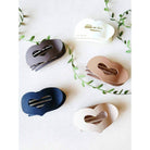 LOVE YOU MORE HAIR CLIPS in five matte neutral shades, heart-shaped claw clips on a light background.