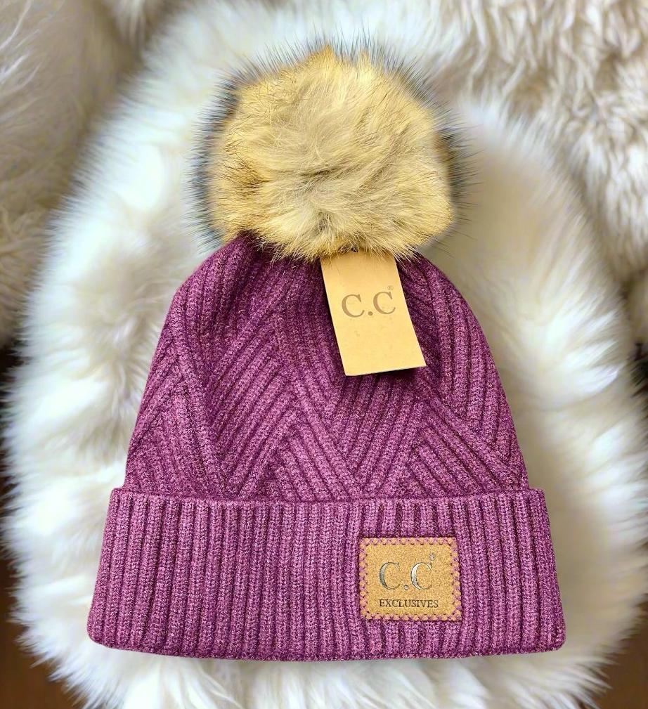 Purple Warm Angle Beanie by C.C. with Faux Fur Pom Pom, showcasing luxurious diagonal pattern for cozy, stylish winter wear.