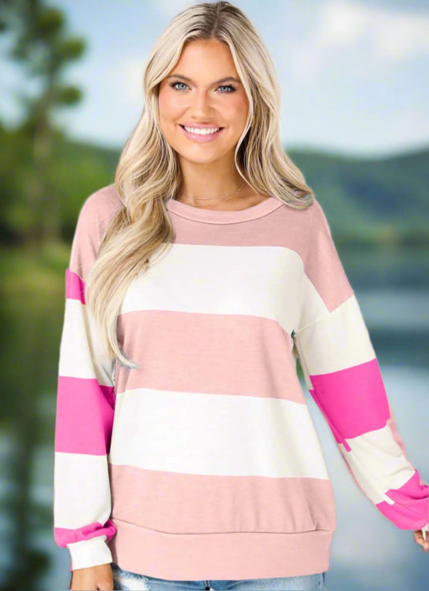 Woman wearing pink striped Going My Way Top with drop shoulder design and long sleeves, perfect for casual and trendy outfits.