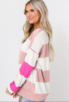 Woman wearing pink striped Going My Way Top with drop shoulder design and long sleeves, perfect for casual outfits.