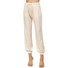 Luxurious beige velvet joggers by See & Be Seen, offering a cozy and stretchy fit, perfect for stylish and comfortable outfits.