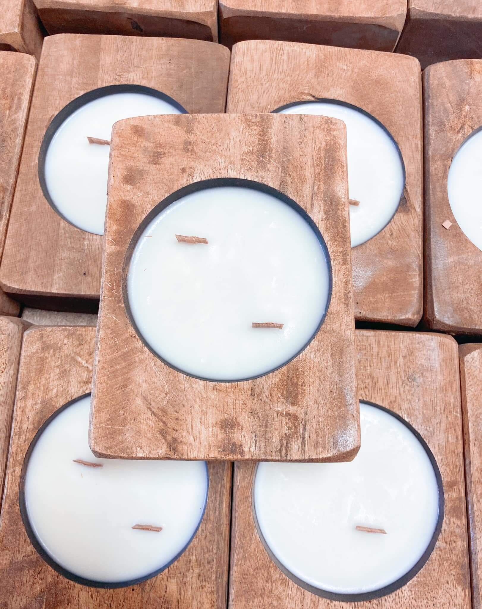 Wooden wick candle in a round dough bowl, featuring crackling wood wicks and creamy soy wax, displayed among similar candles.