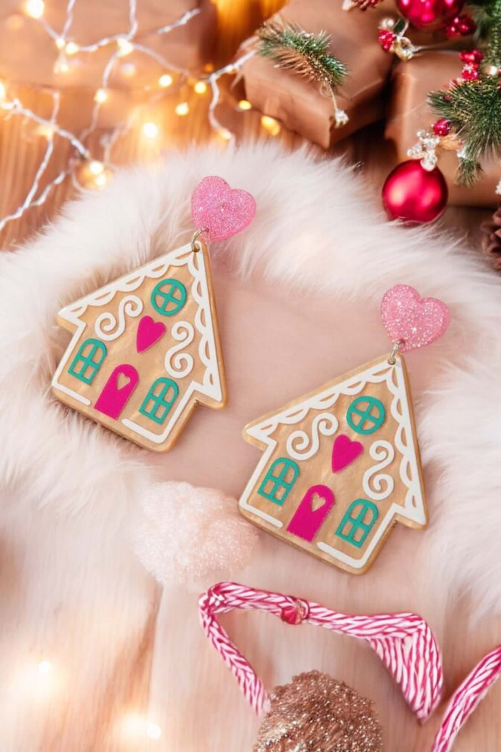 Gingerbread house earrings with pink hearts, perfect holiday accessory for festive celebrations.