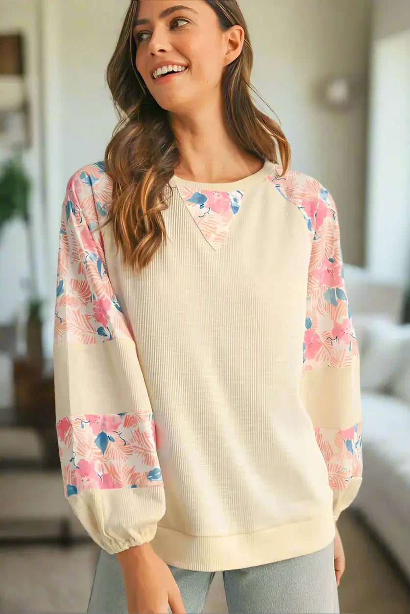 Lightweight vanilla top with floral patchwork sleeves, featuring a crew neck and balloon sleeves for a trendy look.