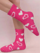 Cozy pink Heart's Delight Socks featuring white heart prints, perfect for adding a sweet touch to any outfit.