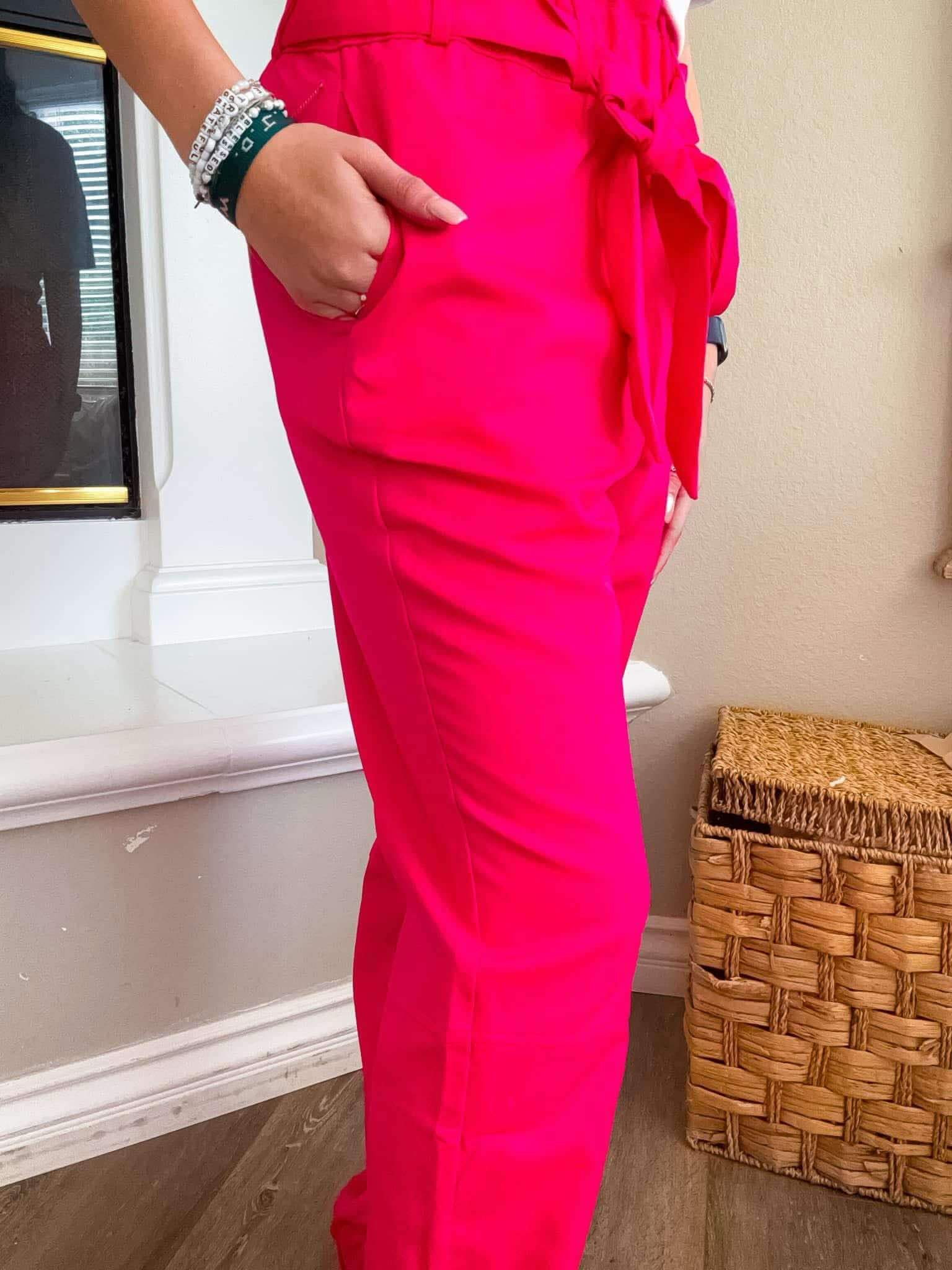 Side view of Pink Power Joggers with pockets and elastic waist, showcasing the vibrant fuchsia fabric.