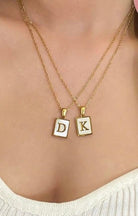 Gold MP Monogram Necklace featuring 'D' and 'K' pendants, stylish layered design for personalized fashion.