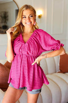 Model wearing Finding Love top in hot pink with ruffled sleeves, perfect for spring and summer outfits.