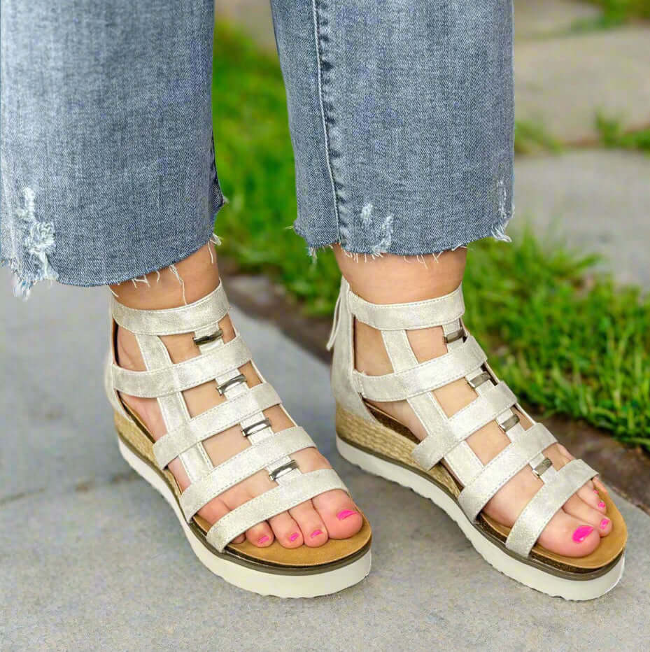Corky's Caged Wedge Sandals in silver, featuring gladiator straps, cork footbed, and espadrille wrap for comfort.