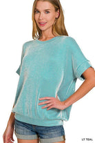 Woman wearing the Coastal Current Ribbed Top in teal, showcasing its lightweight ribbed texture and relaxed fit.